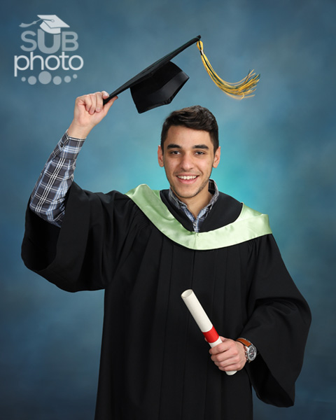 Studio portrait of a man in graduation cap and gown